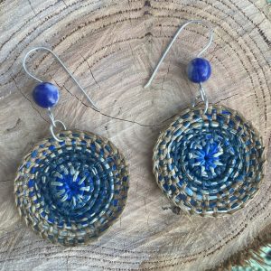 Indigo dyed hand-woven raffia earrings, hanging from hand-formed Argentium Silver hooks, with gemstones. Displayed on The Raffia Kat gift card