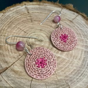 Hand-dyed hand-woven raffia earrings, hanging from hand-formed Argentium Silver hooks, with pink gemstones. Displayed on The Raffia Kat gift card. Pink Lac Dyed.
