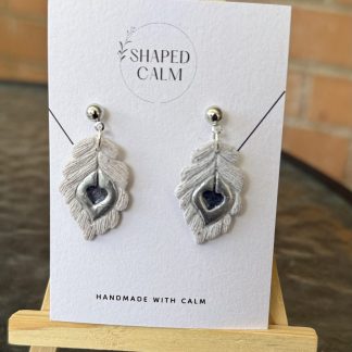 Feather with silver detailing dangle earrings